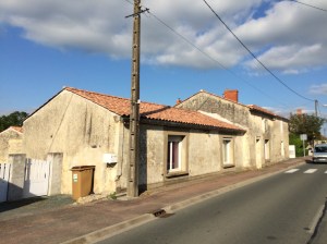 Flatter terra-cotta roofed houses become more the norm.