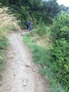 Judith pushing her bike up a steep path along the Camino on the way to the rest house hoping to repair the puncture.