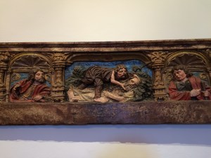An old wooden engraving in the Hostal dos Reis Catolicos depicting the Good Samaritan.