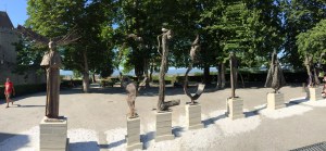 Outside, a series of 9 sculptures by Guy Ferrer spelling the word "TOLERANCE".