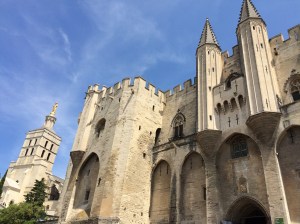 The Palais des Papes and behind it, the Cathedral built in 1100 and later renovated in characteristic Provencal Romanesque style.