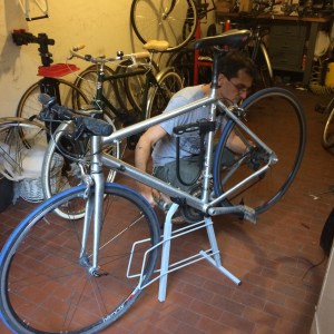 Gianfranco at the Sensa Benzo cycle shop gives Flavio's bike a bit of TLC.