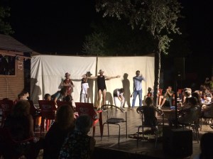 A short slapstick sketch being enjoyed by all alike at the Pineta campsite.